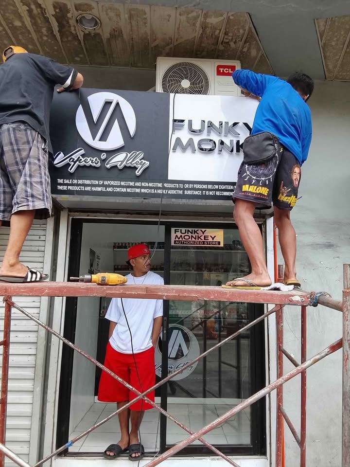 Signstar crew installing a storefront sign from scaffolding