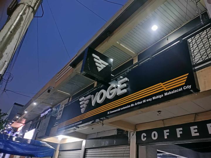 Yoge Coffee dark facade sign with lit white letters