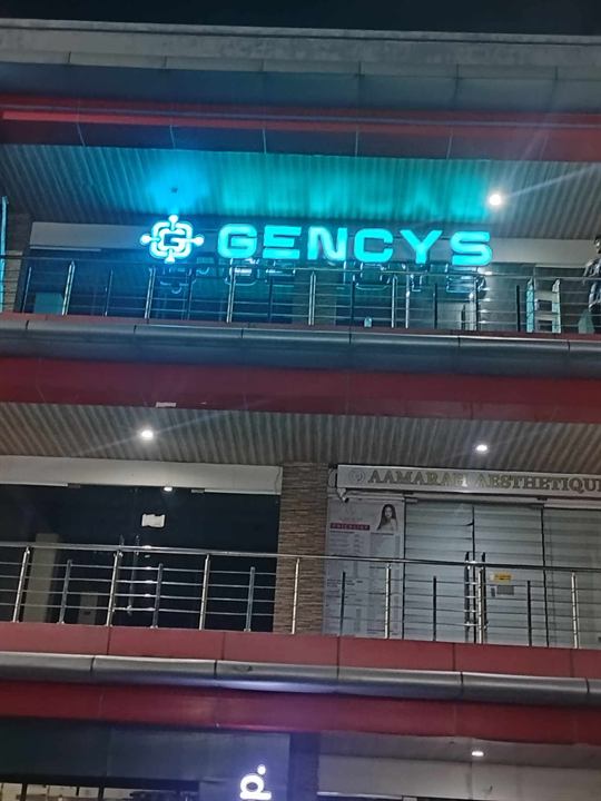 Gencys blue illuminated letters at night